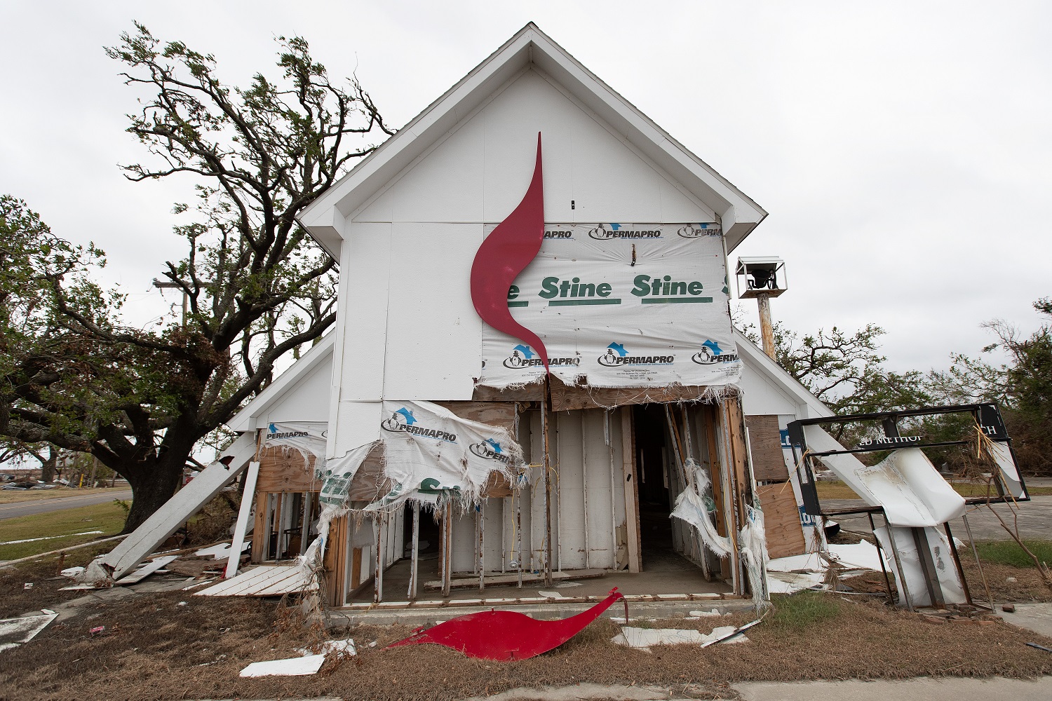 The United Methodist Cross and Flame logo lies in pieces after Hurricane Laura tore through Wakefield United Methodist Church in Cameron, La. Photo by Mike DuBose, UM News.