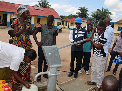 Residents of the communities surrounding the Dingele Health Center celebrate fresh, safe and potable water from their new well. Photo: Central Congo Health Board