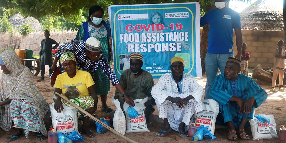 Beneficiaries in Mutum-Daya in the Wurkun Central District in Nigeria receive rice, beans, Maggi seasoning and salt as part of The United Methodist Church’s COVID-19 outreach. The Nigeria Episcopal Area received a Sheltering in Love grant from the UMCOR COVID-19 Response Fund. Photo by Richard Fidelis, UM News.