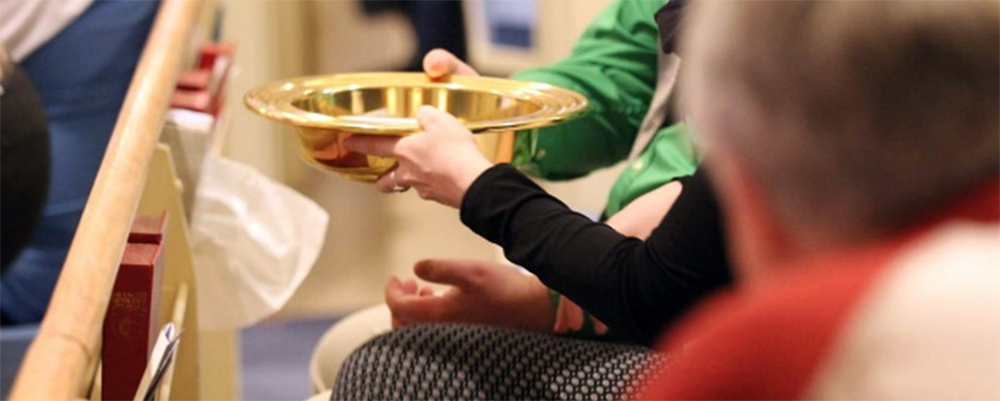 An offering plate is passed down the pew at Cathedral of the Rockies, a United Methodist church in Boise, Idaho. The General Council on Finance and Administration board surveyed U.S. conference treasurers to find out what impact potential church disaffiliations and church closures will have on the apportionment formula over the next four years. 2018 file photo by Mary Kienzle, United Methodist Communications.