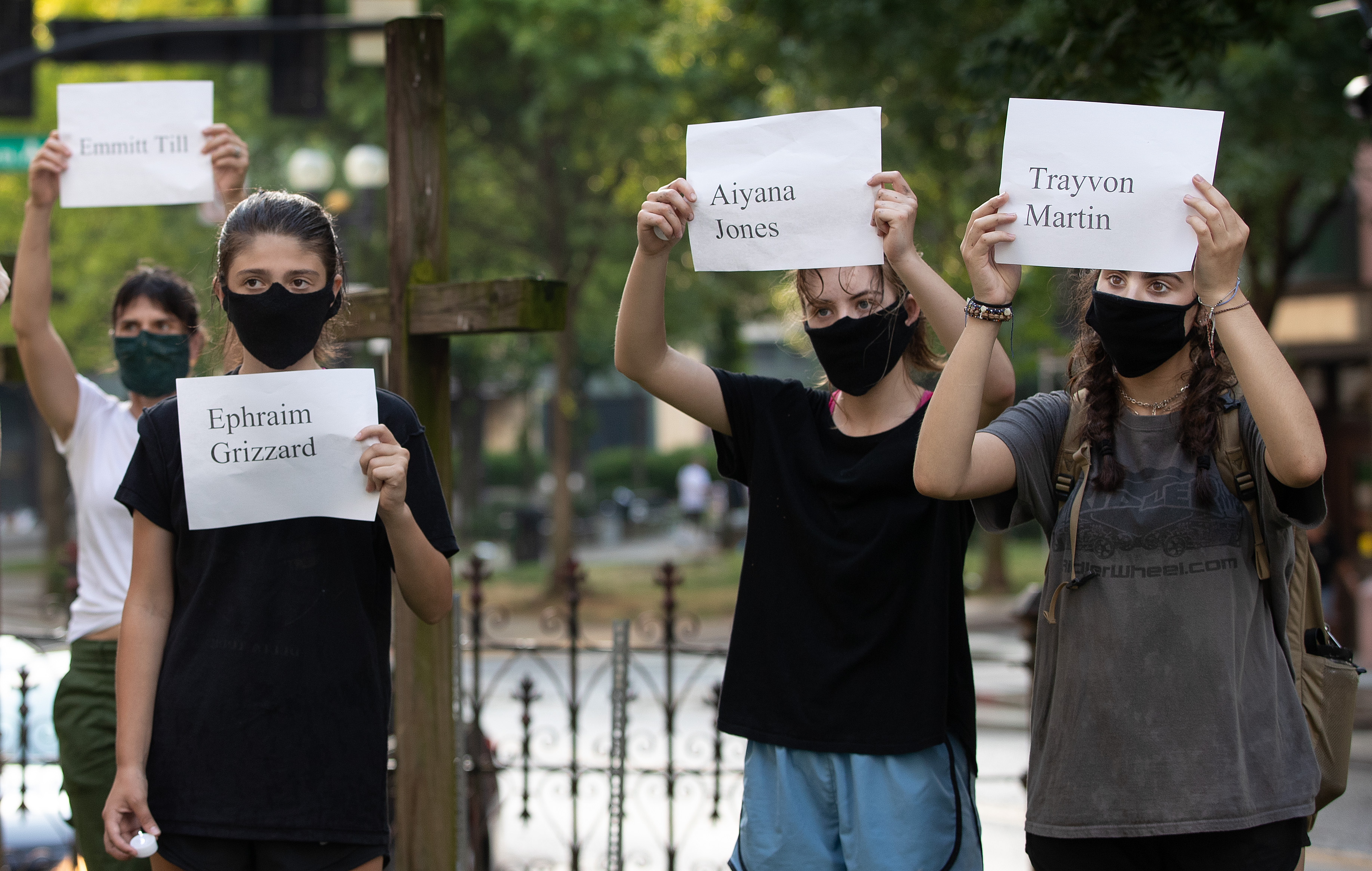 Supporters gather in the courtyard of McKendree United Methodist Church in Nashville, Tenn., during a prayer vigil to grieve and remember people lost to acts of racism. They are holding signs with the names of victims of racial violence. Photo by Mike DuBose, UM News
