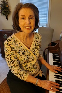 With her antique radio and piano nearby, Karen remembers the Methodist music that helped her make sense as a child of the Civil Rights movement in the sixties as well as the last year with anxiety about COVID, social justice marches and political unrest. Photo courtesy Karen Crenshaw Swenson.