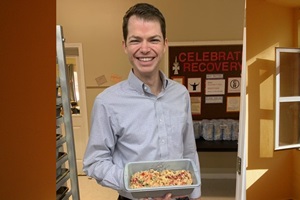 Jonathan Hart, pastor at Robertsdale United Methodist  Church, holds one of the church's fruitcakes used to raise money for missions. Photo courtesy of Robertsdale United Methodist Church.