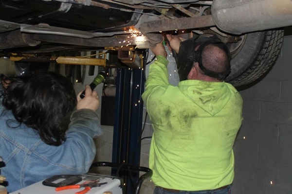 COVID-19 has required many United Methodist missions to rethink its ministries. At Butler United Methodist  Church, the pandemic created a new need, offering car repair to the community. Pictured: Steve Weicht (right) makes a weld as Charles Woods assists during Mechanics on a Mission workday. Photo credit: Jeff Jones, The Butler Bulletin.