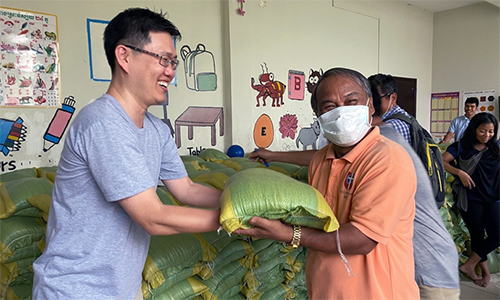 The Rev. Andrew Lee (left) has witnessed hardships related to the coronavirus while serving as a missionary in Cambodia, especially for the poor and marginalized. Lee has helped distribute a 10 kilogram-sack of rice, soaps, reusable masks and sanitize to those suffering hardship during the COVID pandemic. Photo: Courtesy of The Rev. Andrew Lee.