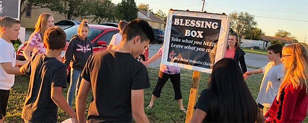 Altus First United Methodist Church youth pray over a Blessing Box they set up. Courtesy photo.