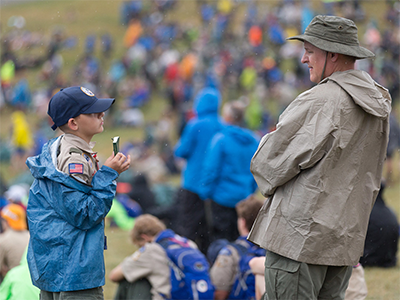A Scout shows his copy of the United Methodist devotional guide "Strength for Service" to an adult leader at the 2017 National Scout Jamboree at the Summit Bechtel Reserve in Glen Jean, W.Va. The General Commission on United Methodist Men supports Scouting and publishes the “Strength for Service” devotional series. File photo by Mike DuBose, UM News.