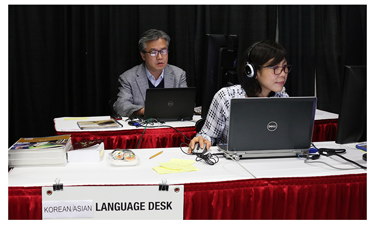 (From left) The Rev. Jacob Lee and Joo Kim work the Korean/Asian-language desk during the 2016 United Methodist General Conference in Portland, Ore. Photo by Kathleen Barry, United Methodist Communications Kathleen Barry