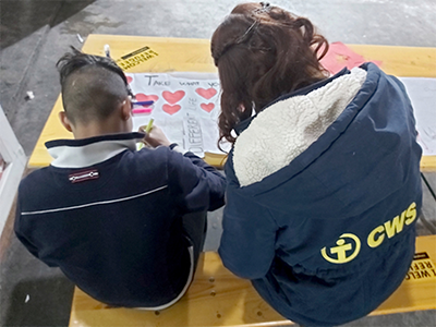 CWS staff member works with one of the boys in her care at a receiving center in Una Sana Canton in Bosnia-Herzegovina. PHOTO: CWS