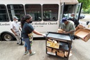 The Rev. Paula Smith (second from left) steadies a cart while volunteers Tim Morgan (in green T-shirt) and Richard Wilson load box lunches for distribution at Gordon Memorial United Methodist Church in Nashville, Tenn. A new study by Gammon Theological Seminary explores the pandemic’s impact on Black United Methodist churches and leaders. File photo by Mike DuBose, UM News.