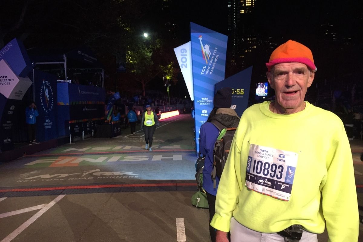 In this photo from 2019, retired United Methodist pastor John Capen stands by the finish line at the Tata Consultancy Services New York City Marathon. Capen also ran in the 2021 race. Photo courtesy of John Capen.