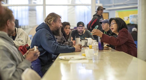 The Rev. Elizabeth McVicker visits with guests at the Sunday fellowship breakfast at First United Methodist Church in Salt Lake City. She is in conversation with Rachel Ramos and Larry Neilson. Photo by Kathleen Barry, UMNS.