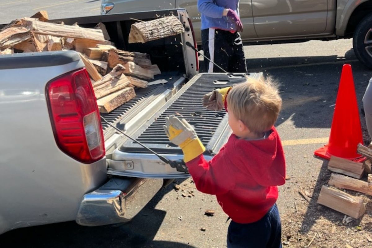 Preschooler Dominic Broomell helps out with Project Firewood at Cullowhee United Methodist Church. Photo by Matthew Broomell.