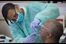 Student doctor Dionne Tompkins treats patient Reginald Hill during a clinic at the Meharry Medical College School of Dentistry in Nashville, Tenn. Photo by Mike DuBose, UMNS.