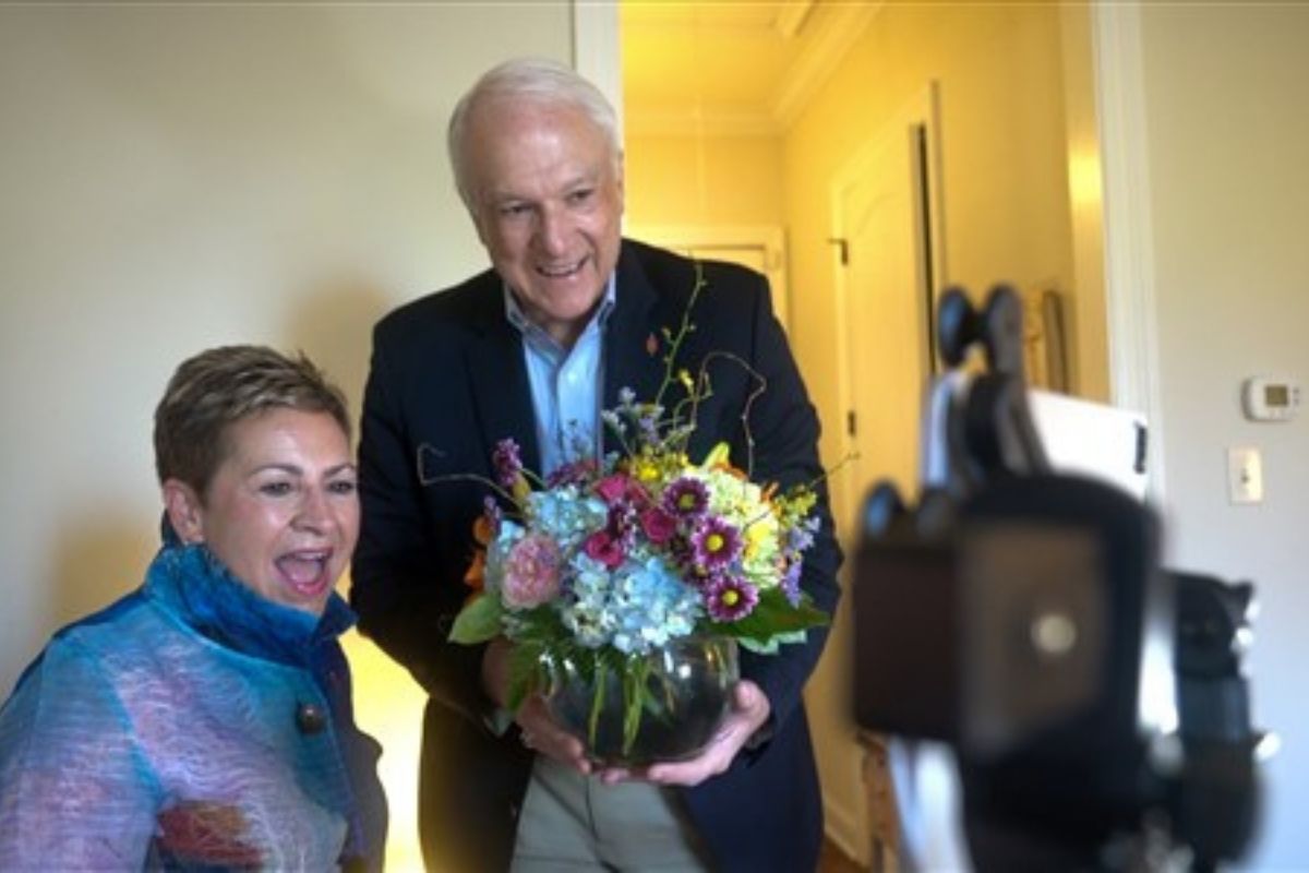 Council of Bishops President Bishop Cynthia Fierro Harvey is surprised by President-Designate Bishop Thomas Bickerton at her house just before she opened the OOB Spring Meeting on Monday, April 25, 2020. (Photo courtesy of Todd Rossnagel and the Council of  Bishops.)