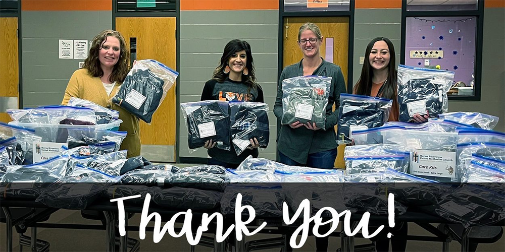 Teachers at Huron Middle share a photo of thanks for Riverview UMC's change of clothing ministry. Photo courtesy of Riverview UMC Facebook page.