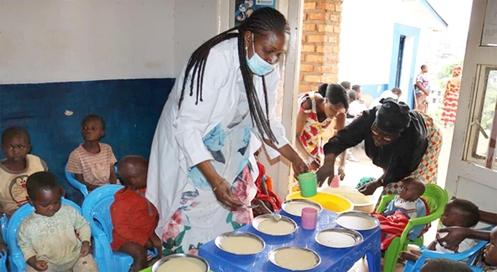 Dr. Marie Claire Manafundu, program officer for the Maternal and Child Health Program in East Congo, serves porridge to malnourished children at United Methodist Irambo Hospital in Bukavu, Congo. Photo by Philippe Kituka Lolonga, UM News.