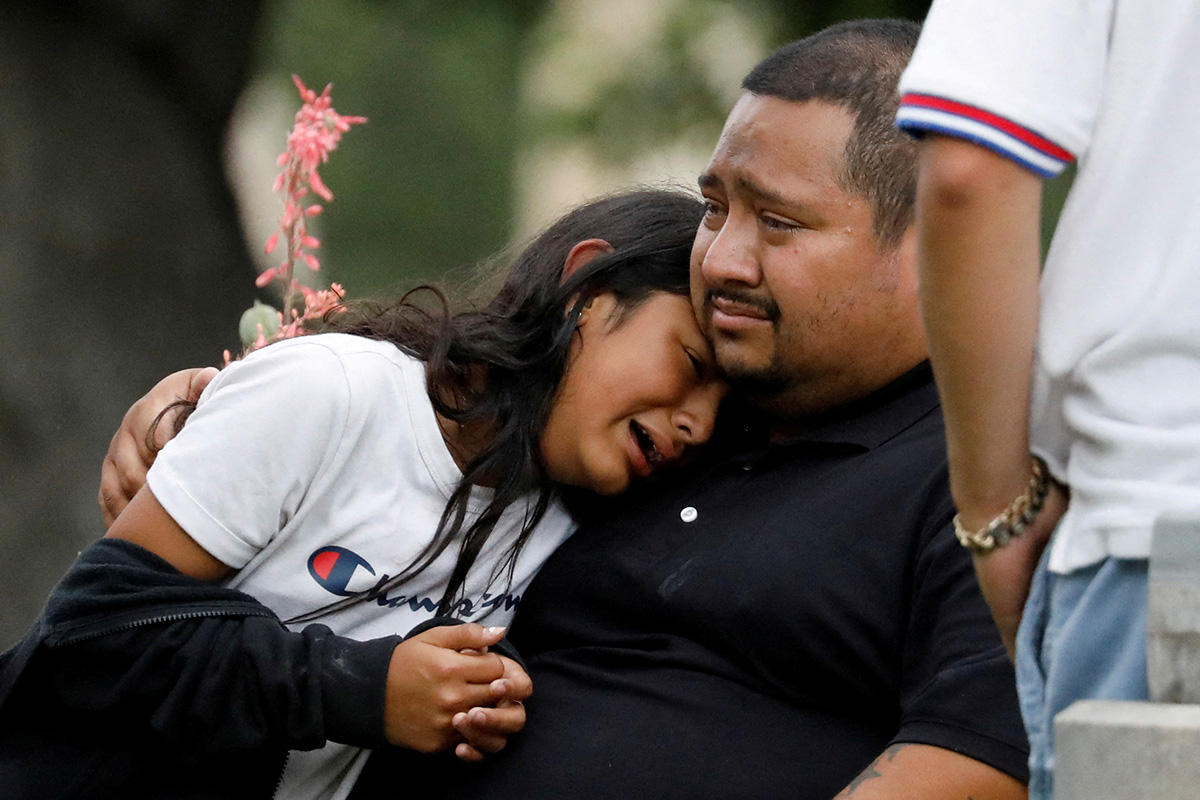 People react outside the Willie de Leon Civic Center in Uvalde, Texas, where students had been transported from Robb Elementary School after a shooting that left 19 children and two teachers dead. Photo by Marco Bello, Reuters.
