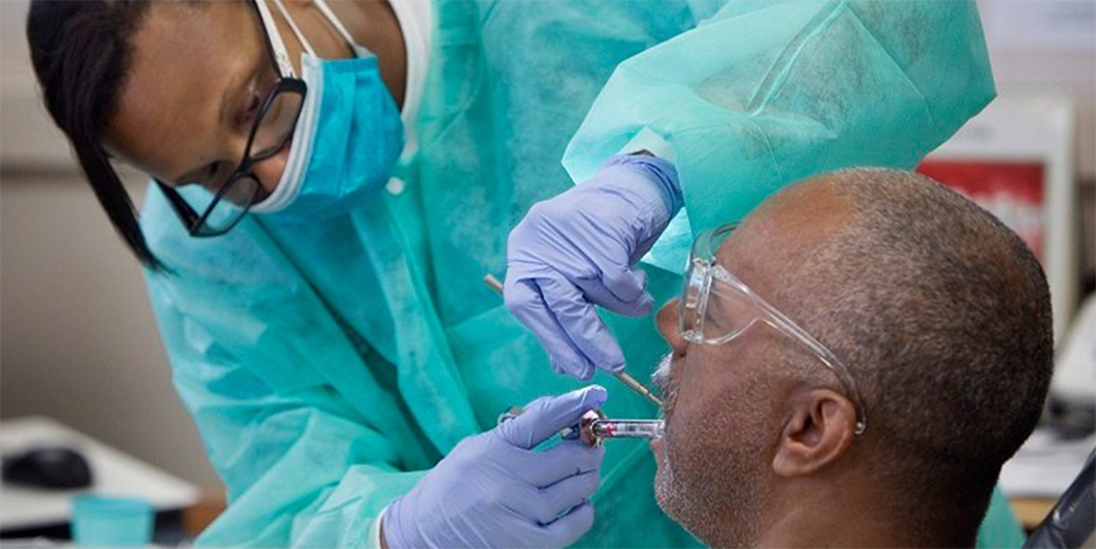 Student doctor Dionne Tompkins treats patient Reginald Hill during a clinic at the Meharry Medical College School of Dentistry in Nashville, Tenn. Photo by Mike DuBose, UMNS.