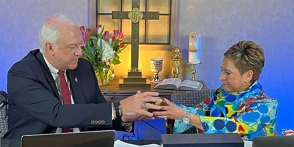 New Council of Bishops President Bishop Thomas J. Bickerton receives the gavel from outgoing President Bishop Cynthia Fierro Harvey during the spring meeting, Friday, April 29, 2022. (Photo courtesy of the COB.) New Council of Bishops President Bishop Thomas J. Bickerton receives the gavel from outgoing President Bishop Cynthia Fierro Harvey during the spring meeting, Friday, April 29, 2022. (Photo courtesy of the COB.)