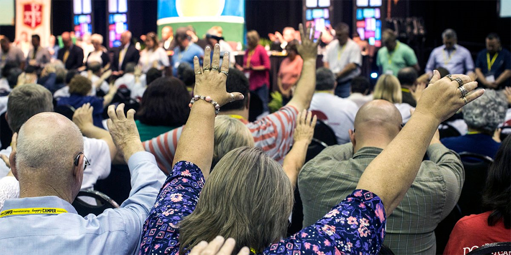 Attendees of the 2017 Kentucky Annual Conference in Bowling Green, Ky., raise their arms in prayer during a "Worshipful Work, Plenary." On May 10, The Judicial Council released a ruling that says U.S. annual conferences cannot disaffiliate from the denomination under current church law. File photo by Kathleen Barry, UM News