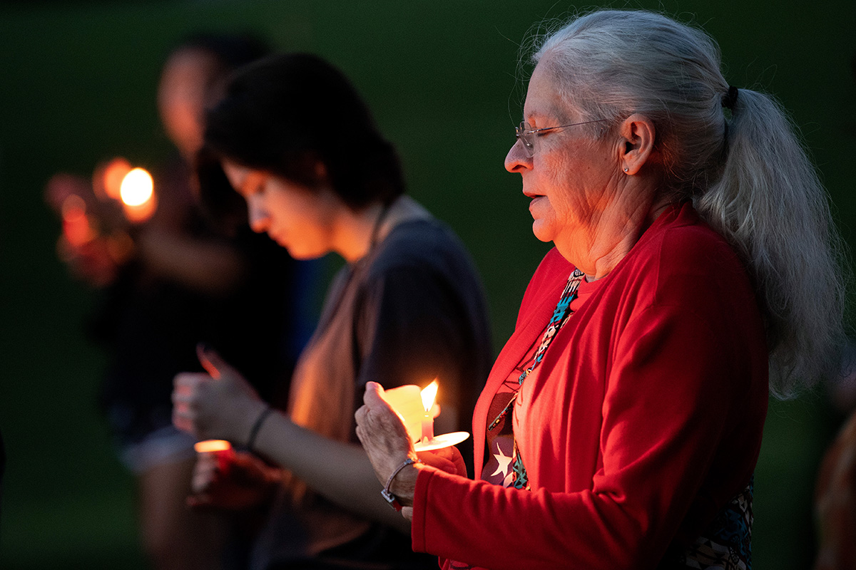 Sheila Jones (right) joins in a service of remembrance for missing and murdered indigenous women during the Native Moccasins Rock gathering in Bon Aqua, Tenn. The program is sponsored by the Committee on Native American Ministries of the Tennessee-Western Kentucky Conference of The United Methodist Church. Photo by Mike DuBose, UM News.