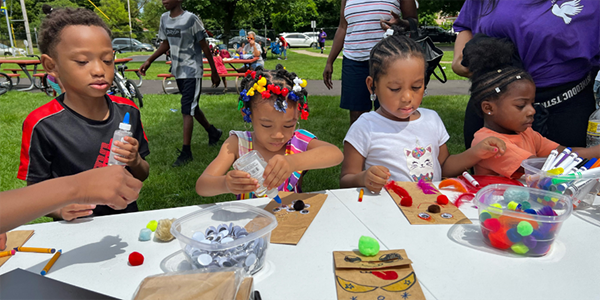 Children attending the Family, Friends, and Fun Day Carnival at Washington Heights UMC in Battle Creek made homemade puppets. Led by volunteer Clovis Bordeaux, this activity “teaches them that anything can be a puppet, and they can use their imagination to create whatever they want.” ~ photo courtesy Battle Creek Community Foundation