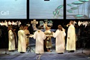 Bishops from the US and central conferences stand around the circular communion table of General Conference to lead those gathered in the Great Thanksgiving.
