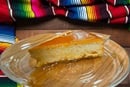 Flan Napolitano photo shows a slice of Bilha Alegria's Flan Napolitano on a table