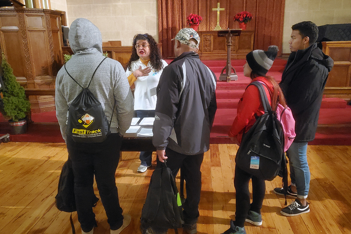Niurka Meléndez, a founder of Venezuelans and Immigrants Aid, offers practical information and advice to newcomers trying to navigate New York City. The aid group is a partner with the United Methodist Church of St. Paul and St. Andrew in assisting the recent influx of asylum seekers there. Photo by K Karpen.