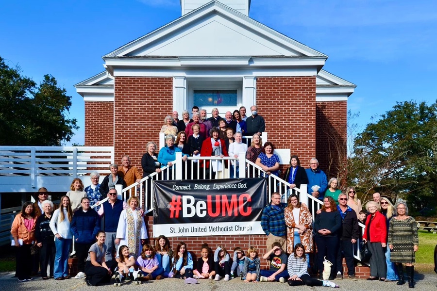 Members of St. John United Methodist Church, Avon, NC pose in front of their #BeUMC sign.
