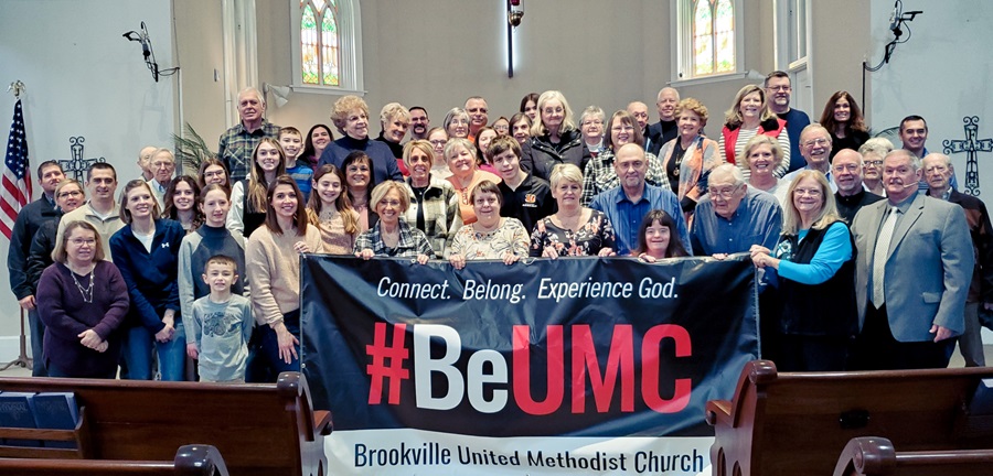 Members of Brookville United Methodist Church, Brookville, Indiana pose in front of their #BeUMC sign.