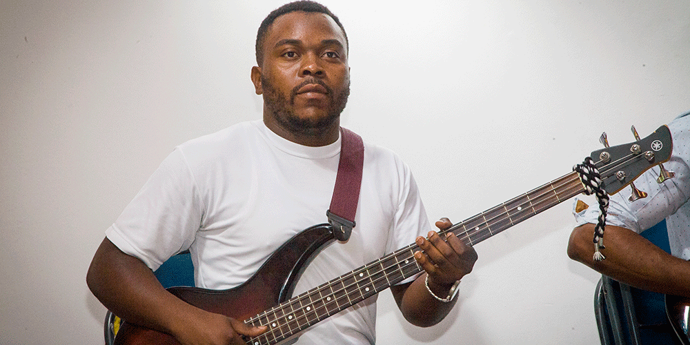 Christian Adosi playing  guitar that was gifted by Sara and Richard Rathgeber