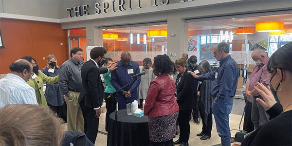 Members of the Connectional Table lay hands on Bishop Mande Muyombo (center), chair of the Connectional Table, and Judi Kenaston (fourth from right), interim chief connectional ministries officer, during the group’s meeting Feb. 24 in Atlanta. The leadership body helps determine the budget of The United Methodist Church. Photo by Jim Patterson, UM News. Members of the Connectional Table lay hands on Bishop Mande Muyombo (center), chair of the Connectional Table, and Judi Kenaston (fourth from right), interim chief connectional ministries officer, during the group’s meeting Feb. 24 in Atlanta. The leadership body helps determine the budget of The United Methodist Church. Photo by Jim Patterson, UM News.