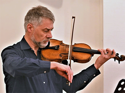 Newly elected Bishop Stefan Zürcher plays the violin during the meeting of the Standing Committee on Central Conference Matters. The committee deals with issues that affect The United Methodist Church’s regions in Africa, Europe and the Philippines. Zürcher is set to become bishop of the Central and Southern Europe Central Conference in August. Photo by Klaus Ulrich Ruof, Germany Central Conference. 