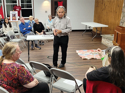 Ron Williams (center) talks to CONAM members and guests about the ramifications of the Doctrine of Discovery at Camp Innabah.
