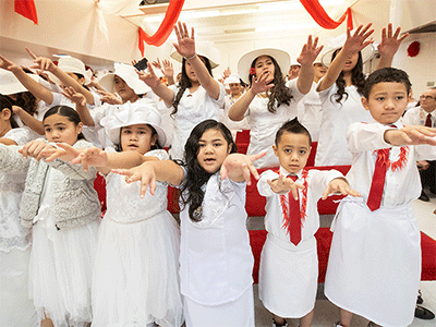 Members of the choir sing during the chartering service for Ola Toe Fuataina United Methodist Church in Anchorage, Alaska. Photo by Mike DuBose, UM News.