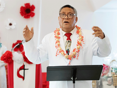 The Rev. Fa’atafa Fulumu’a leads singing during the chartering service for Ola Toe Fuataina United Methodist Church. Photo by Mike DuBose, UM News.