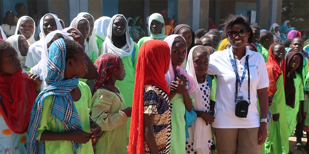 The Rev. Claudine Leary (wearing white T-shirt) with youth at a refugee camp where her nonprofit, Watoto Reads, built a new school. (Photo: Courtesy Claudine Leary)