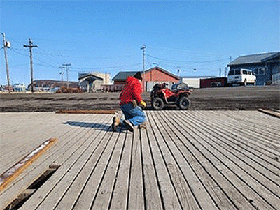One of the California-Pacific Disaster Response Team members helps rebuild a basketball court in Stebbins, Alaska.