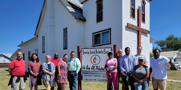 Terri Leone (2nd from left )and Drew classmates visit Rev. Calvin Hill (left of the church sign) at Browning UMC in Montana Terri Leone (2nd from left )and Drew classmates visit Rev. Calvin Hill (left of the church sign) at Browning UMC in Montana
