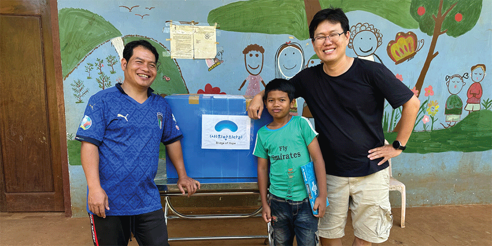 One of the ministries of the Methodist Church in Cambodia is sharing children’s clothes with Mondulkiri Methodist Church. Missionary Andrew Lee is pictured in the far right. (Photo: Courtesy of Janice Lee)