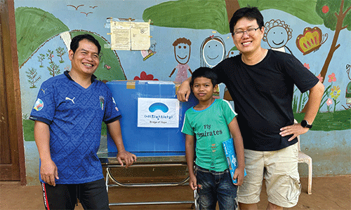 One of the ministries of the Methodist Church in Cambodia is sharing children’s clothes with Mondulkiri Methodist Church. Missionary Andrew Lee is pictured in the far right. (Photo: Courtesy of Janice Lee)