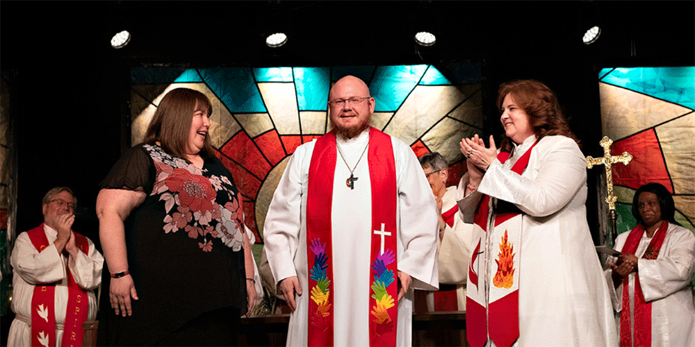 Rev. Michael Vollmer was one of eight people ordained as Elder in the Michigan Conference this year. During the ordination service at the 2023 Michigan Annual Conference, Michael was joined by his wife, Sarah, who also serves as the Annual Conference Registrar for the Michigan Conference (left), and Rev. Suzie Hierholzer, Associate Pastor of Discipleship at Birmingham: First UMC (right). Suzie is a close friend of the Vollmers and has been a mentor for Michael. She and her family are a big part of why they came to Michigan following seminary at Garrett-Evangelical Theological Seminary in Evanston, IL. ~ MIphoto/John Woodring