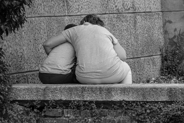 mother hugging child consolation Adult hugging a child offering consolation.