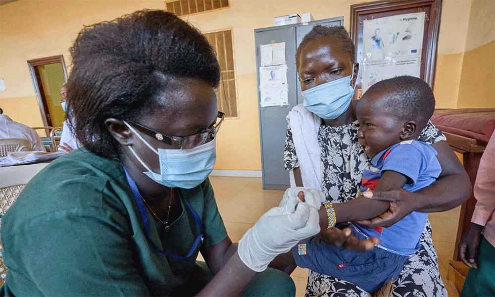 Nursing student Lucia Daud James takes a blood sample from a child to test for malaria in the Sika Hadid Primary Health Care Center in Wau, South Sudan. James is a student at the Catholic Health Training Institute, which is sponsored by Solidarity with South Sudan.  Photo: Paul Jeffrey/Life on Earth.