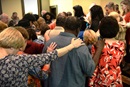 Diverse group praying Wells UMC diverse-group-praying