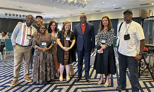 From left, Pacome Nguessan, Matt Crum, Priscilla Muzerengwa, Jennifer Rodia, Ashley Gish, North Katanga Area Bishop Mande Muyombo, Poonam Patodia and Chilima Karima celebrate together at the end of training on regionalization. All but the bishop work for United Methodist Communications. Photo courtesy of United Methodist Communications.