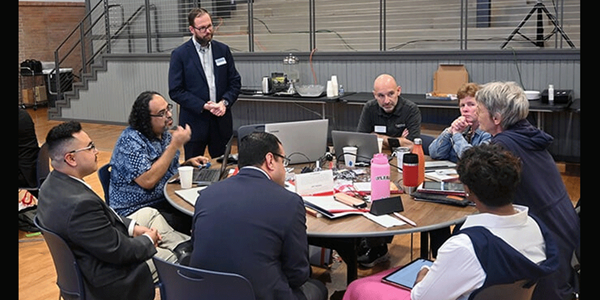 David Scott (standing), senior director of mission theology and strategic planning for the United Methodist Board of Global Ministries, listens to members of the Connectional Table discuss colonialism Oct. 24 during orientation training in Dallas. Photo by Jim Patterson, UM News.