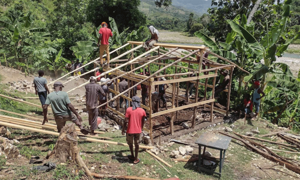 Volunteers of Jeremie Rising frame a shelter for a family home. This joint venture project with Next Generation costs about $3,000 and takes a week to build. The goal is to erect 20 such structures every year. ~ photo courtesy Jeremie Rising